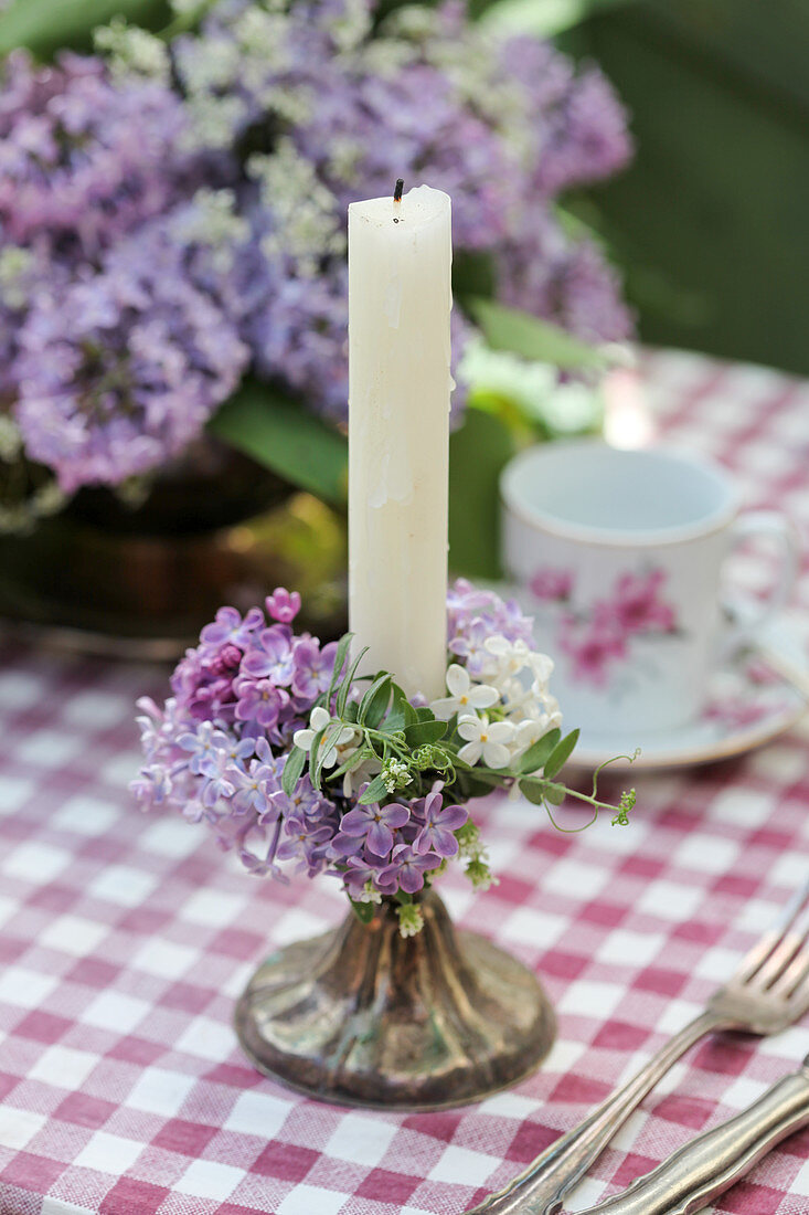 Wreath of lilac florets around candle