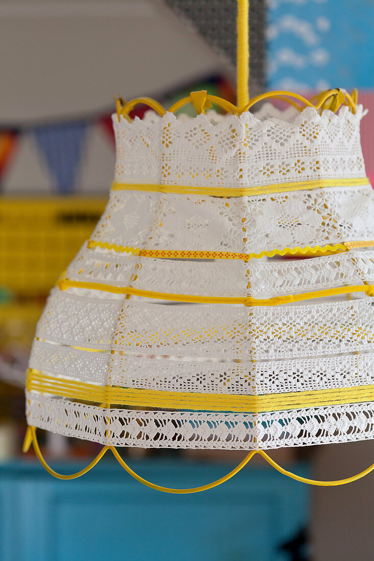 Lampshade made from yarn, lace trim and yellow and white ribbons