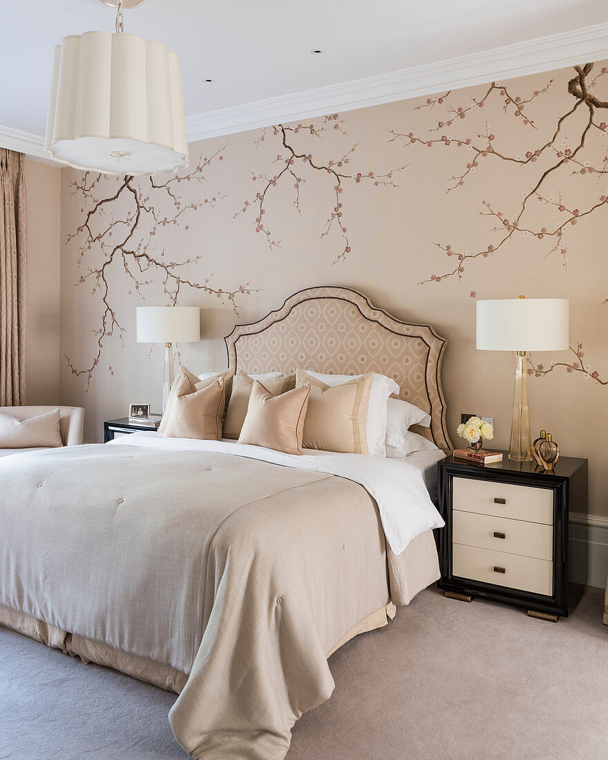 Elegant bedroom in nude shades with Japanese-style branches painted on wall
