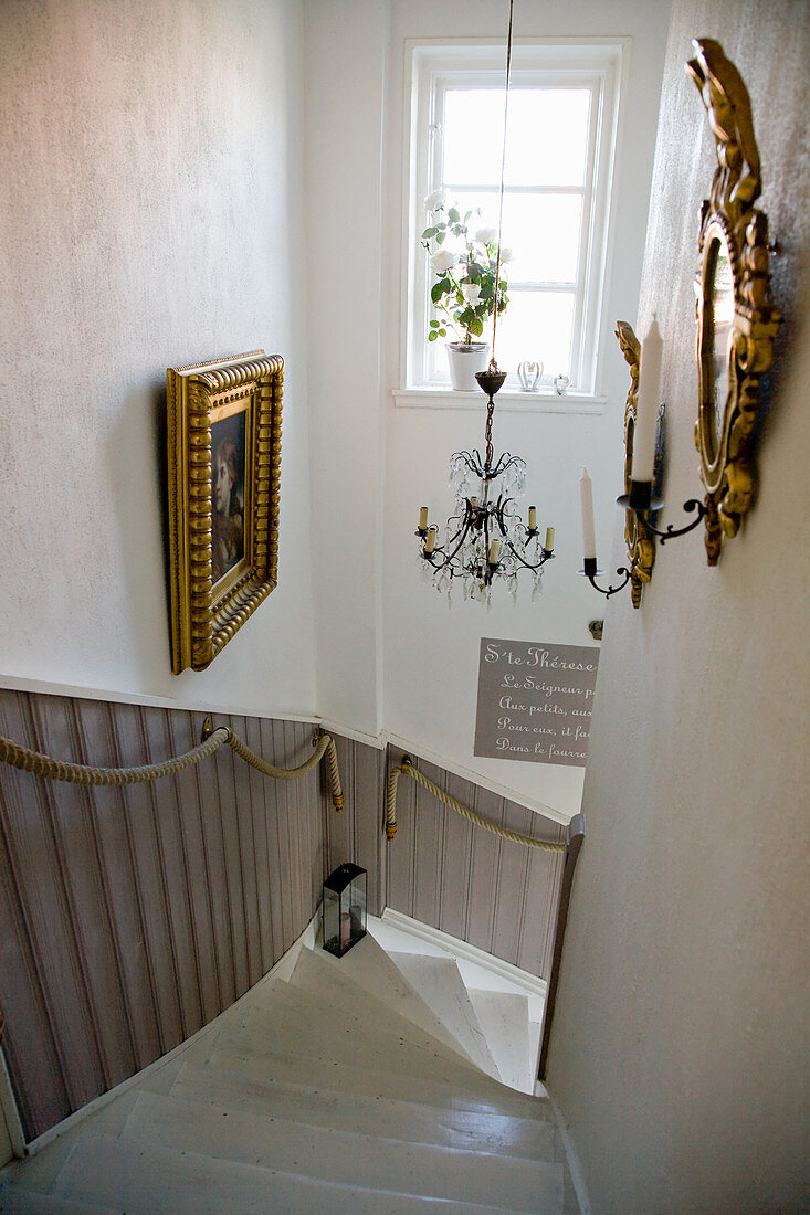Rope handrails along staircase with wainscoting