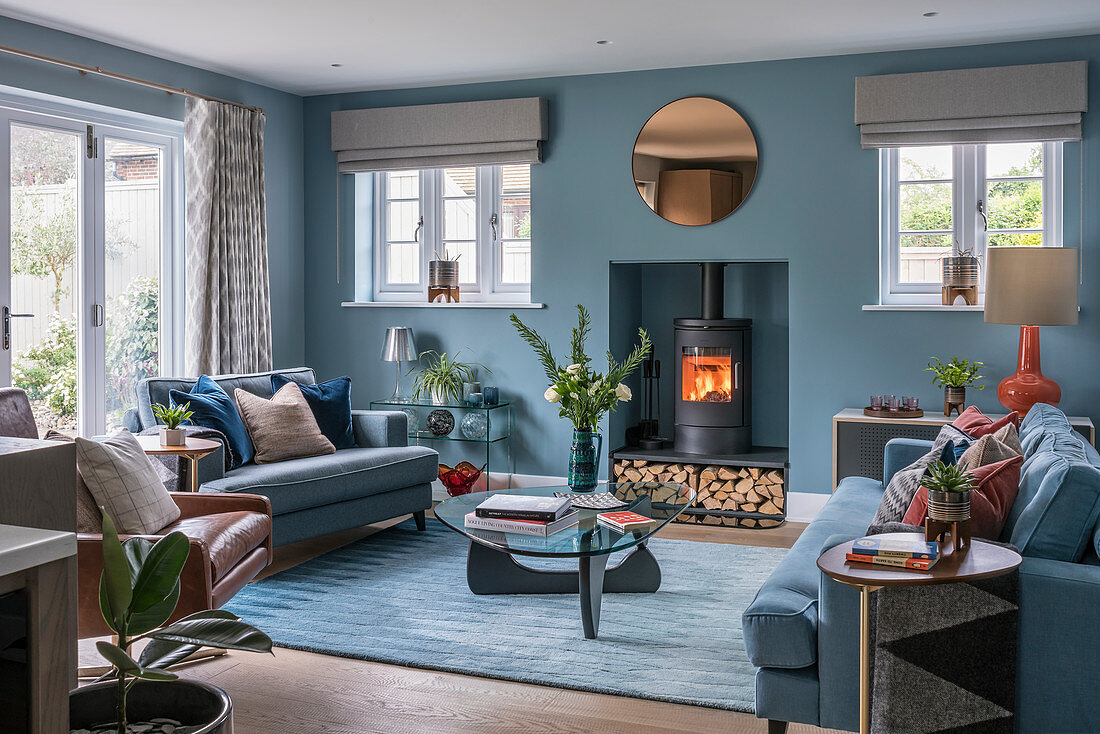 Wood-burning stove in niche in classic blue living room