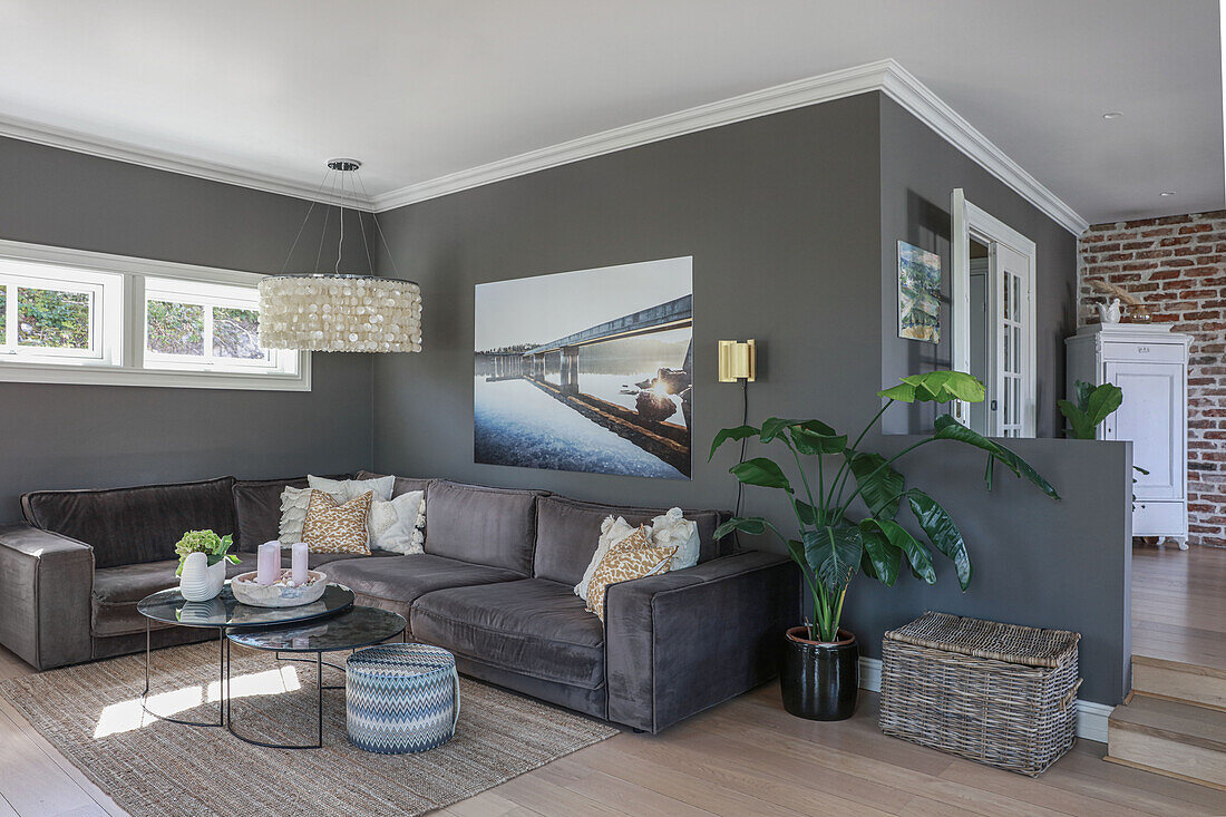 Sofa set and coffee table in open-plan interior with dark walls