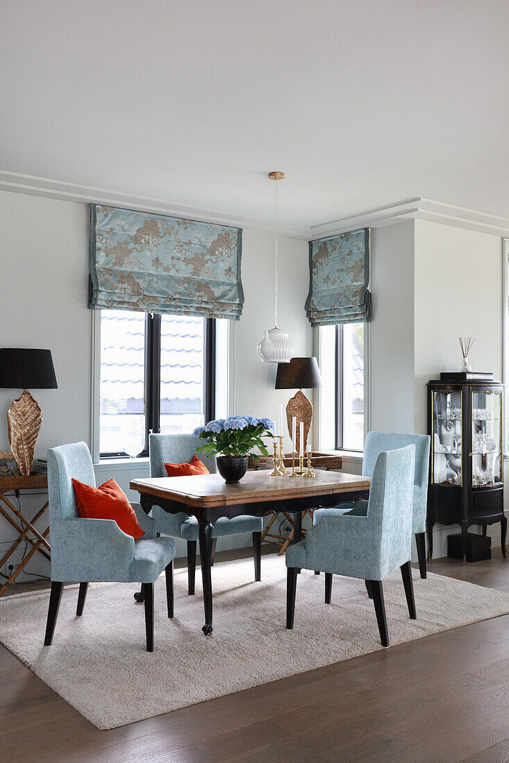 Elegant chairs with blue-grey upholstery in dining area
