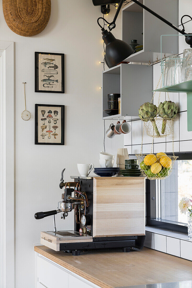 Coffee machine in kitchen with grey shelf modules on wall
