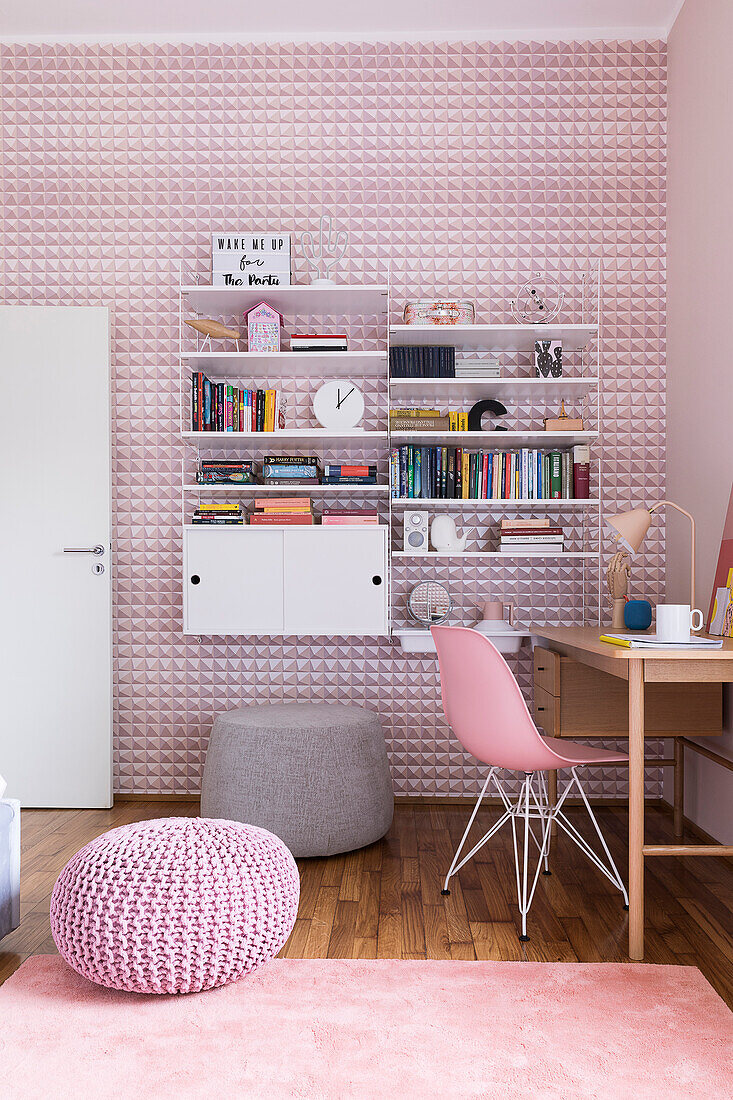 Desk and shelves in girl's bedroom with pink wallpaper