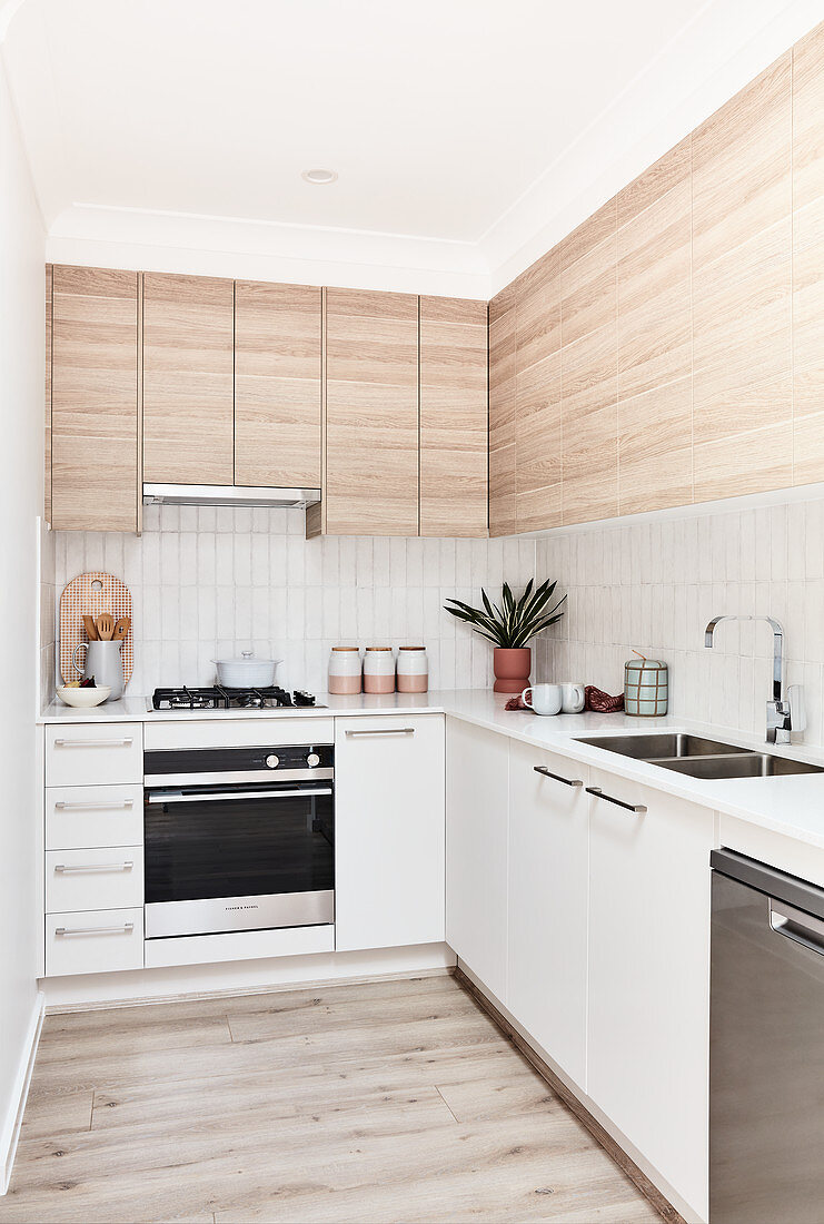 Schlichte moderne Küche mit Fronten in Weiß und Holzoptik