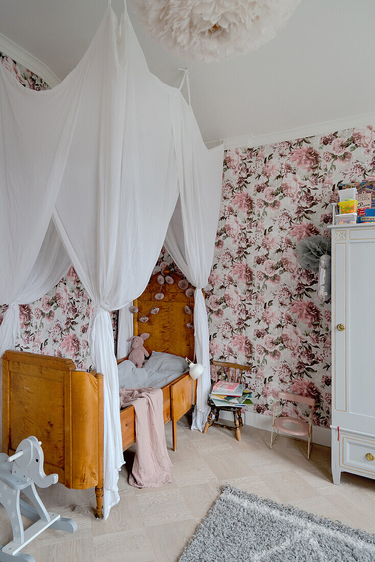 Canopy over antique bed in nostalgic children's room