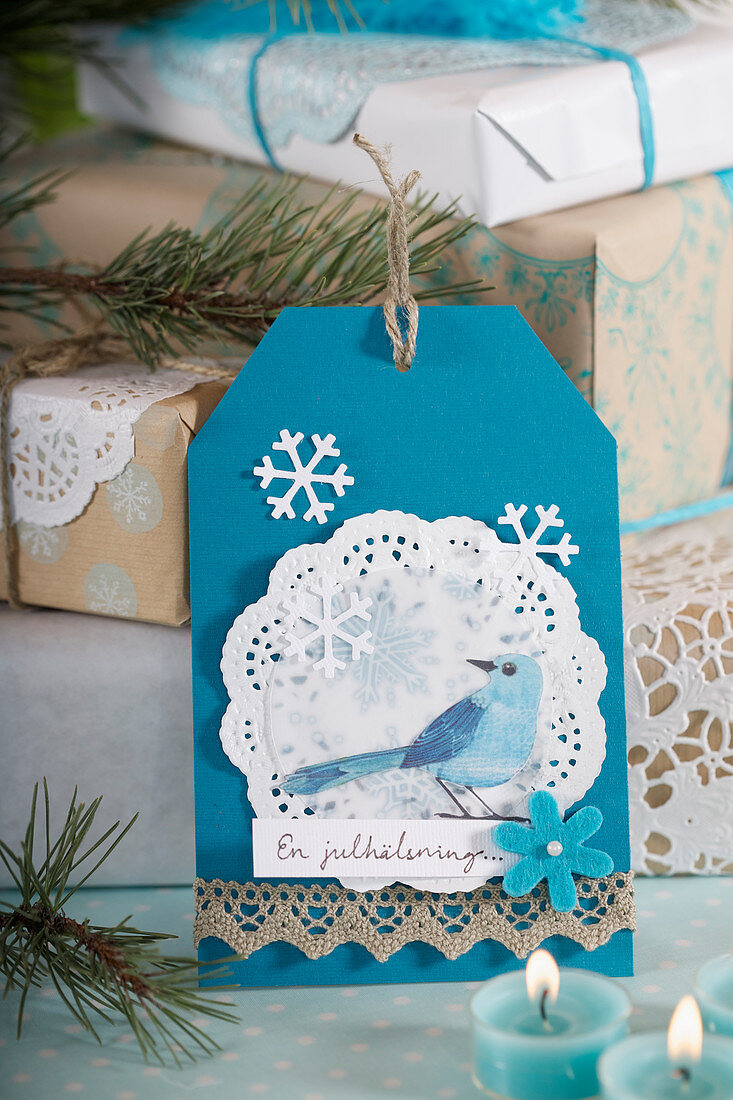 A DIY Christmas card with a blue-and-white bird motif