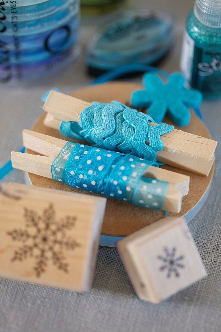 Blue decorative ribbons on clothes pegs