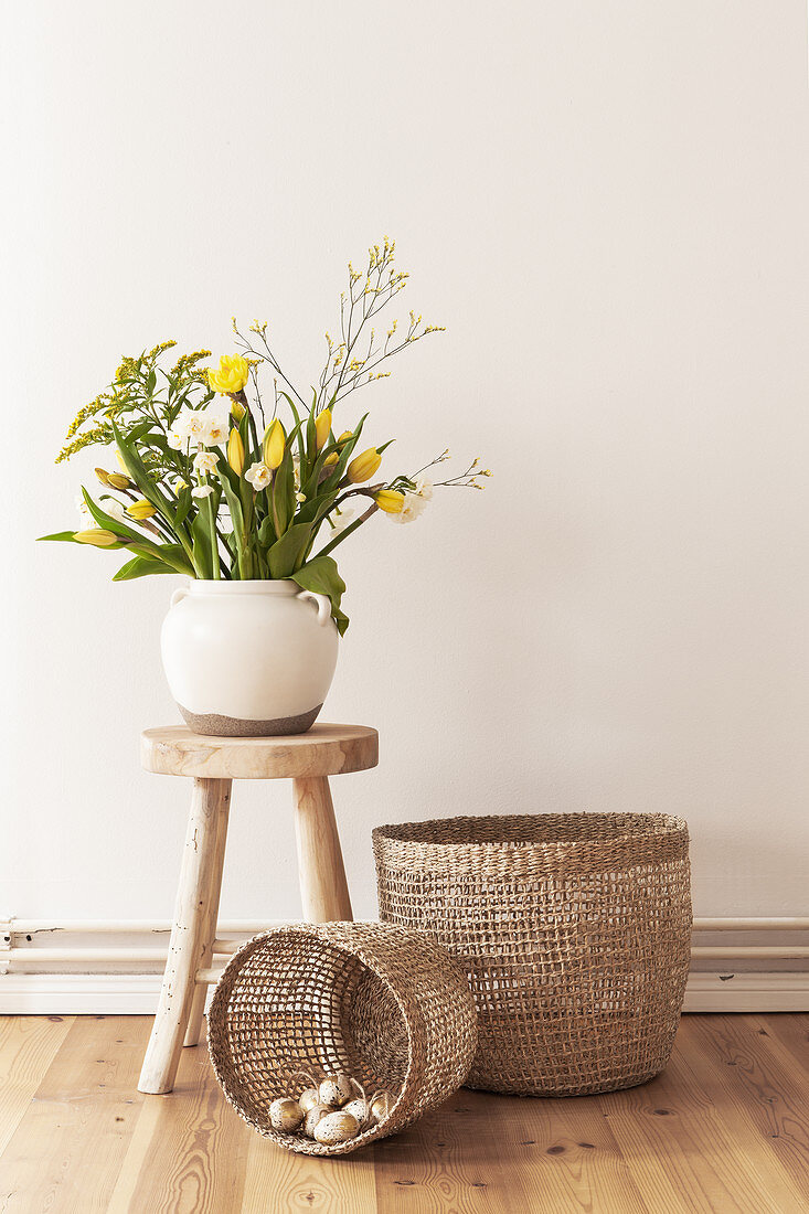 Spring bouquet with yellow tulips on a wooden stool