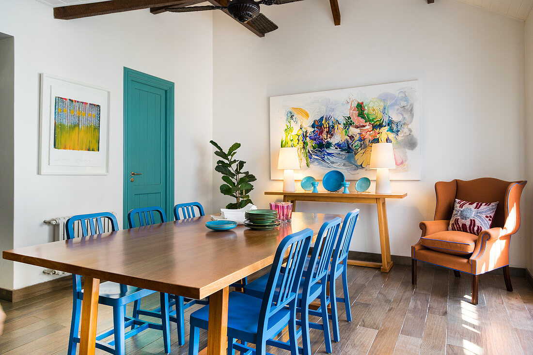Blue wooden chairs and armchair in dining area