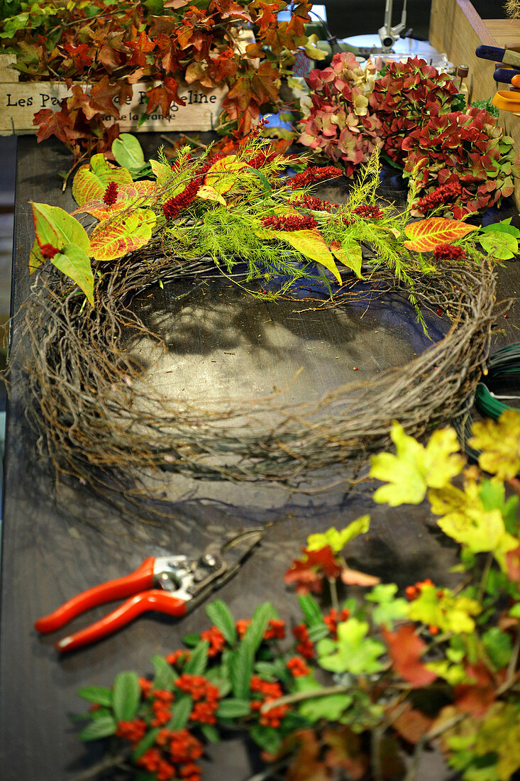Tying an autumn wreath with knotweed