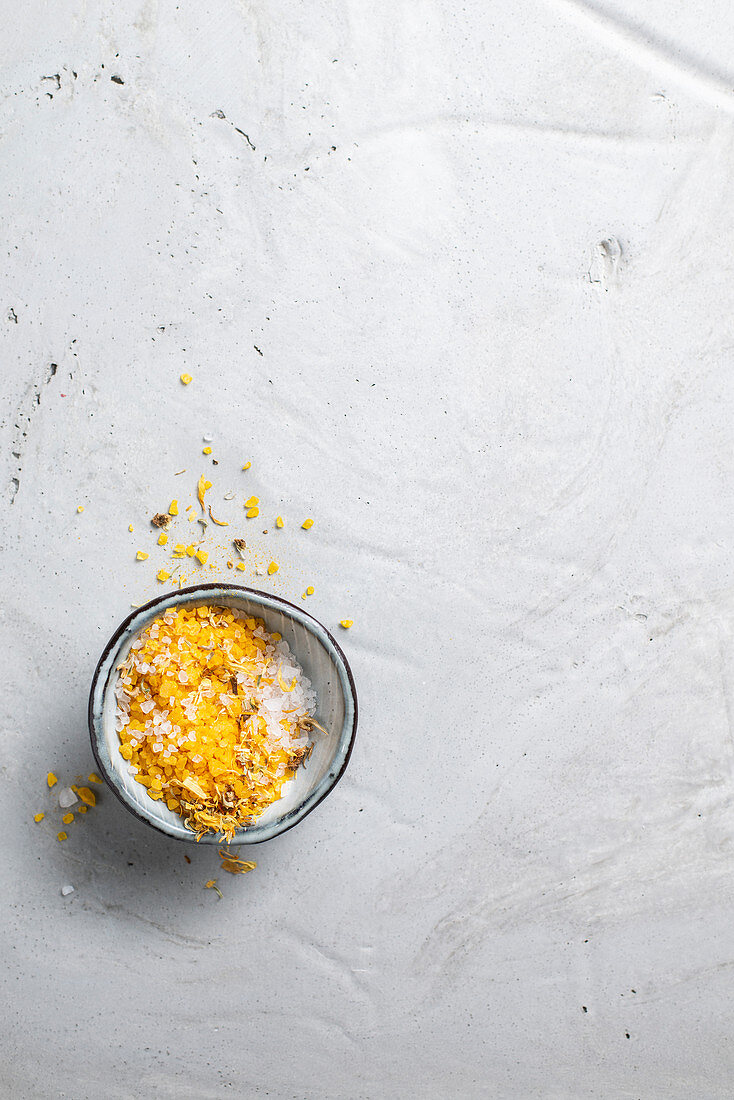 Yellow bath salts with dried flower petals