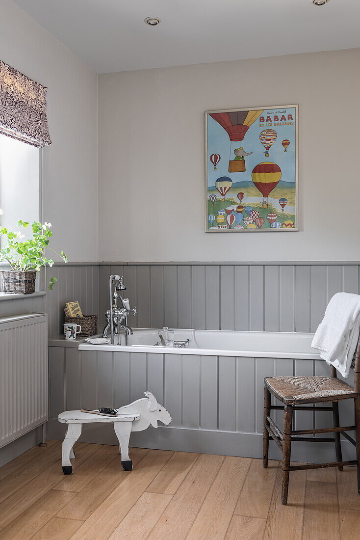 Grey tongue and groove bathroom with artwork