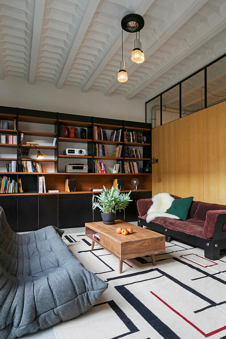 Sofas and coffee table in front of bookshelves in loft apartment