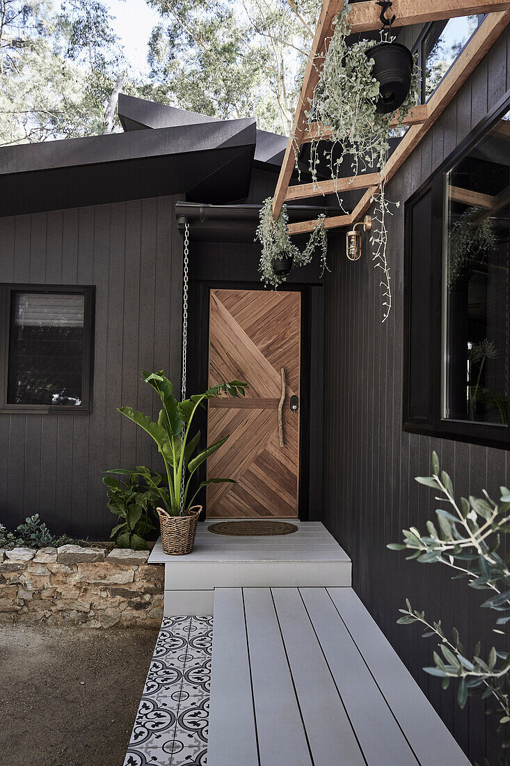Dark brown painted wooden house, entrance area