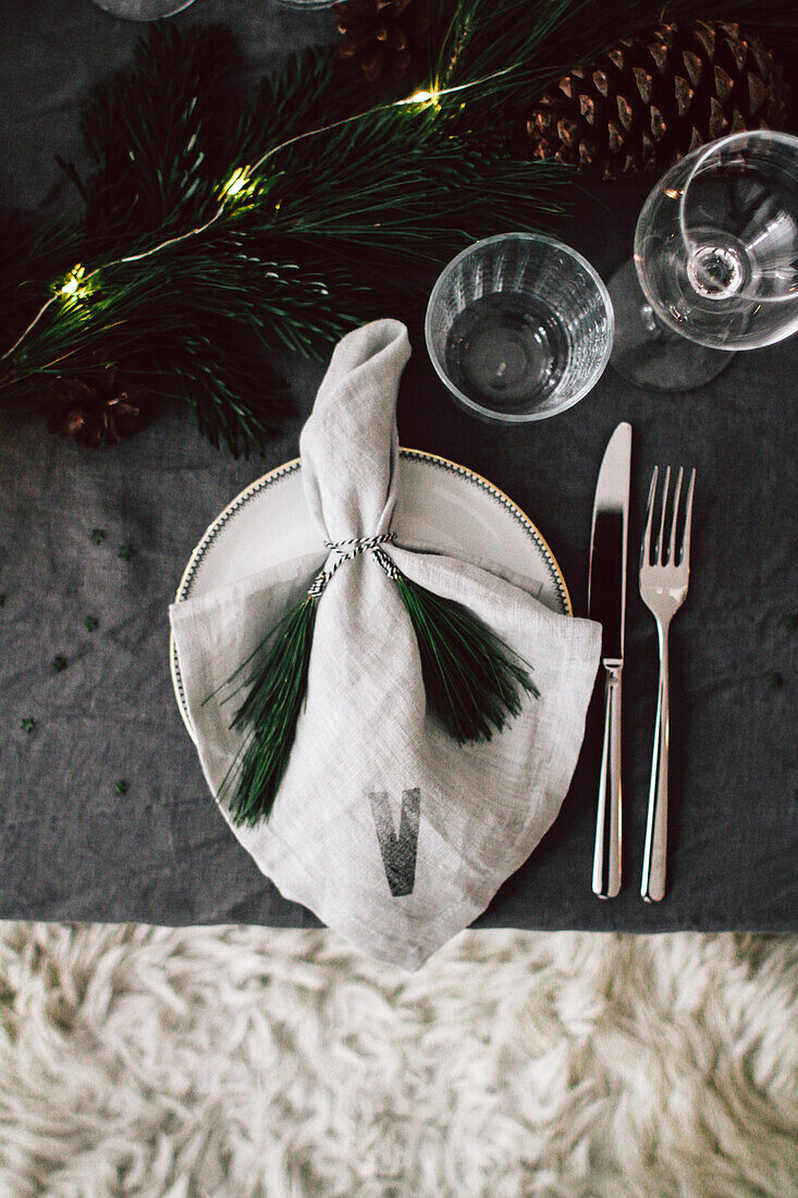 Christmas set with initial personalised linen napkin and pine-needle tassels as napkin rings