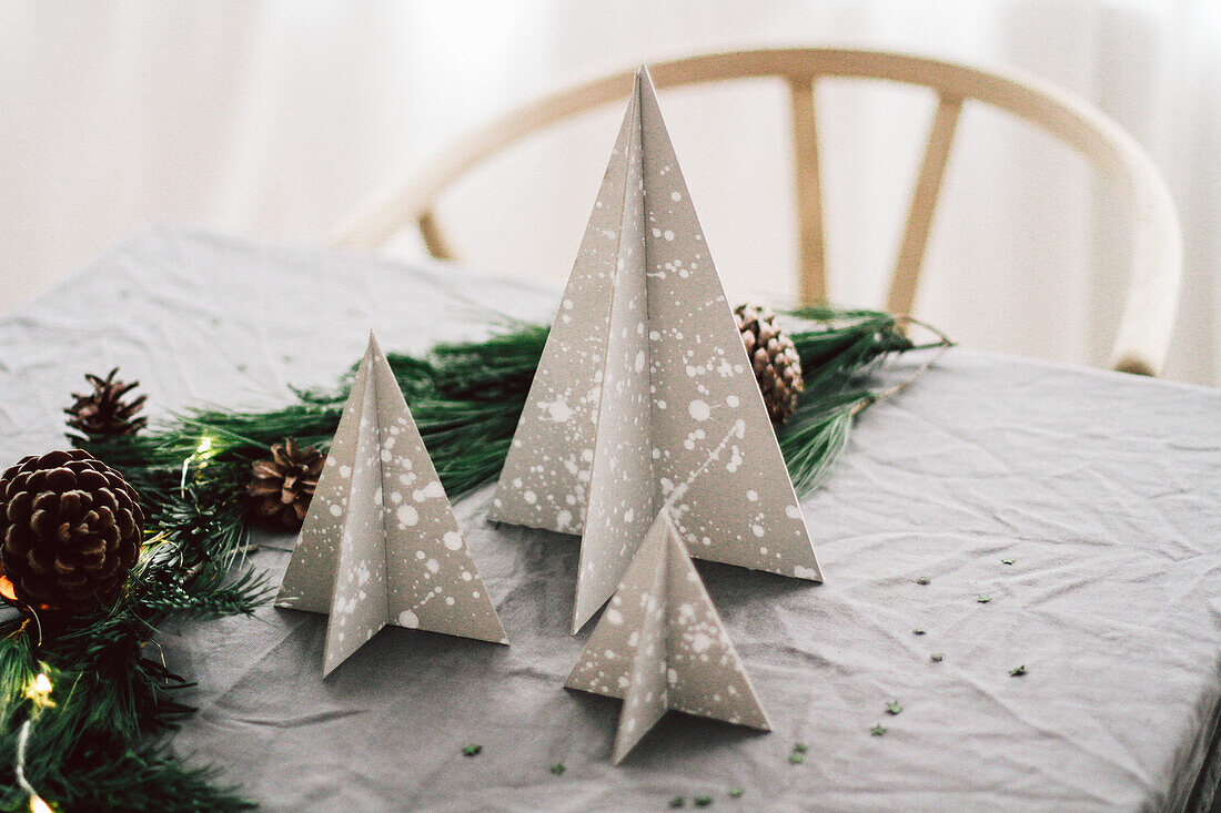 DIY speckled Christmas tree decorations made from grey cardboard
