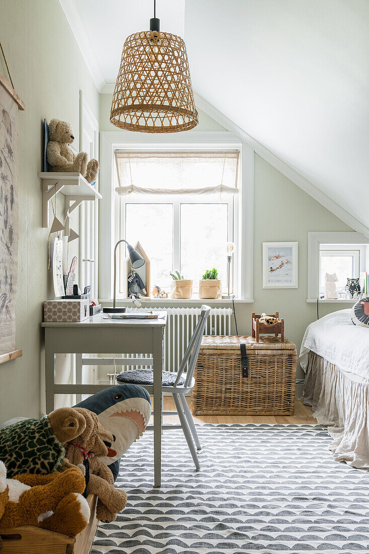 Bright children's room with desk in a country house style in the attic