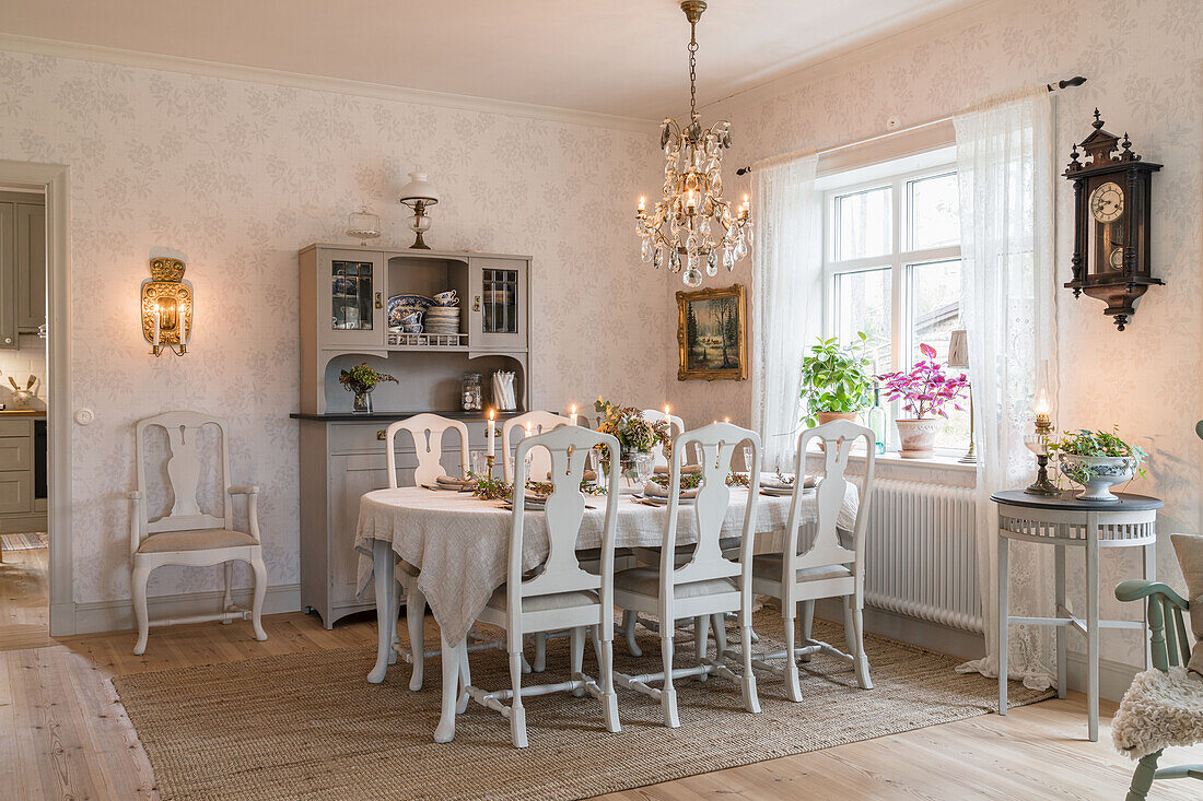 Dining area with set table and sideboard in country style