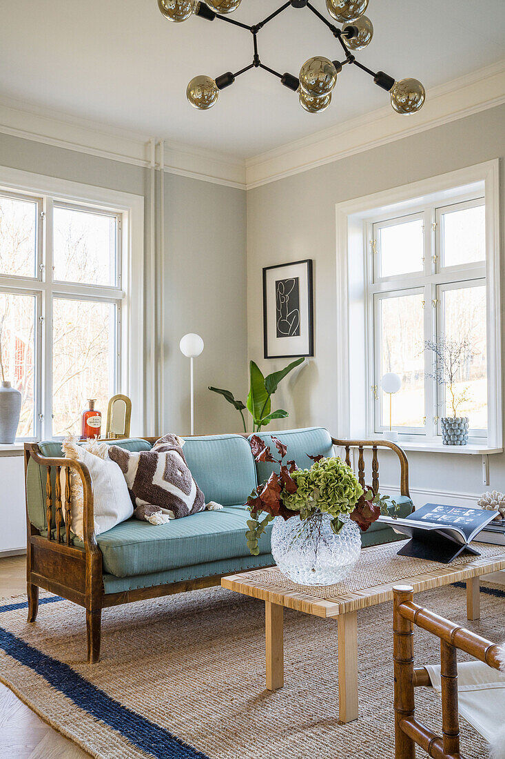 Light blue upholstered sofa and coffee table in bright living room