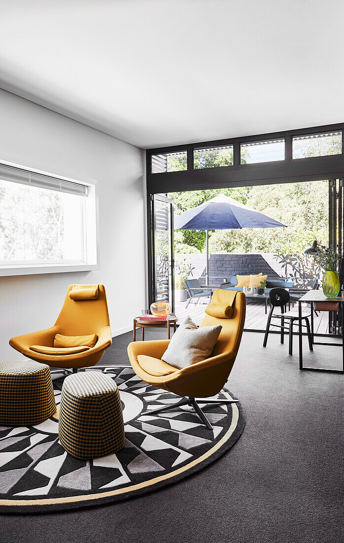 Seating area with designer armchairs on a rug with geometric pattern