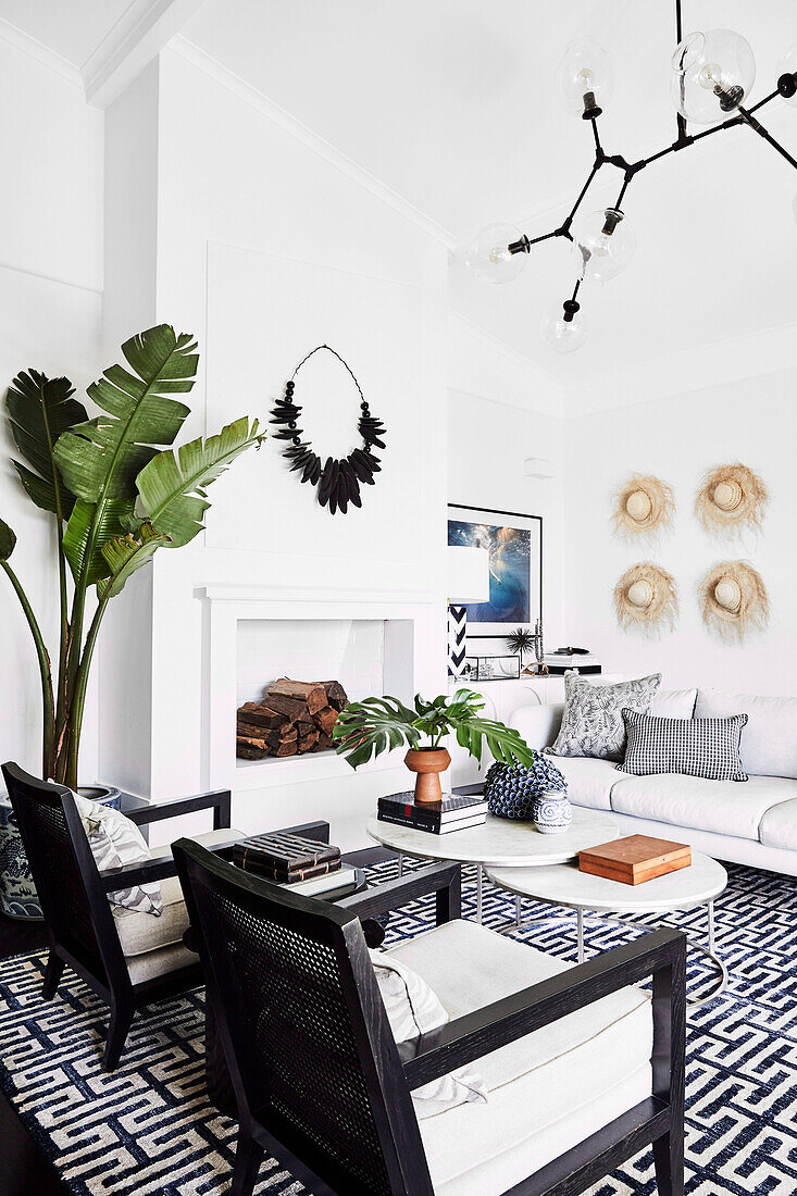 Sitting area in black and white with faux fireplace