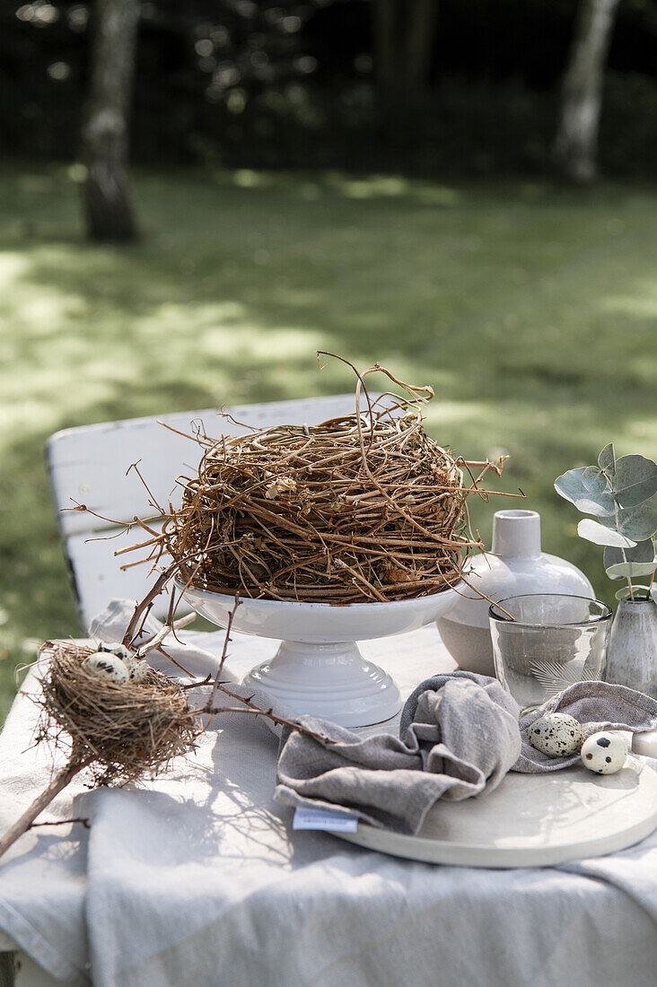 A nest on Easter table set in the garden