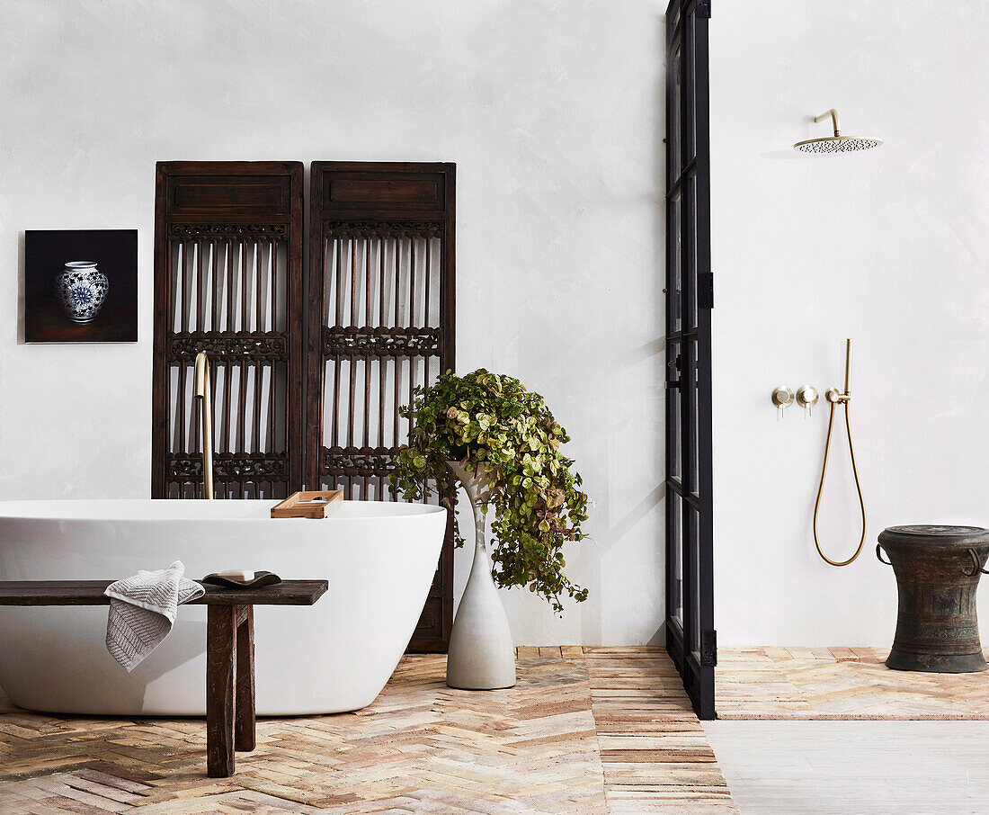 Freestanding bathtub, wooden bench, antique Chinese screen and separate shower area