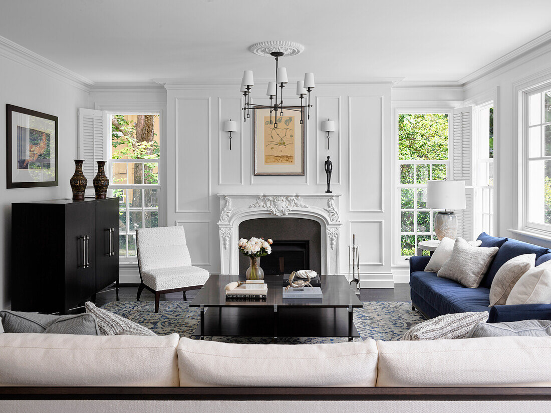 Living room with upholstered sofas in white and blue and fireplace