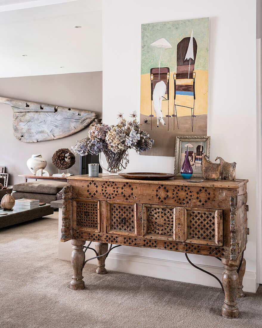Console table made from old Omani doors in space opening out into the living area. The rudder of an old spanish Galleon has been hung on the wall