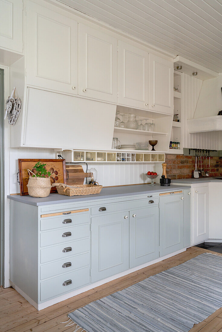 Bright country-house kitchen with white and light grey cupboards