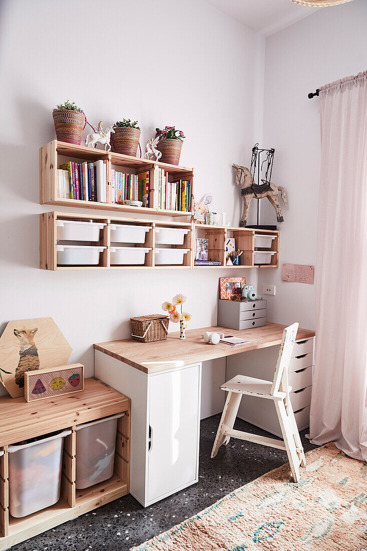 Desk with chair and wooden shelves in the children's room