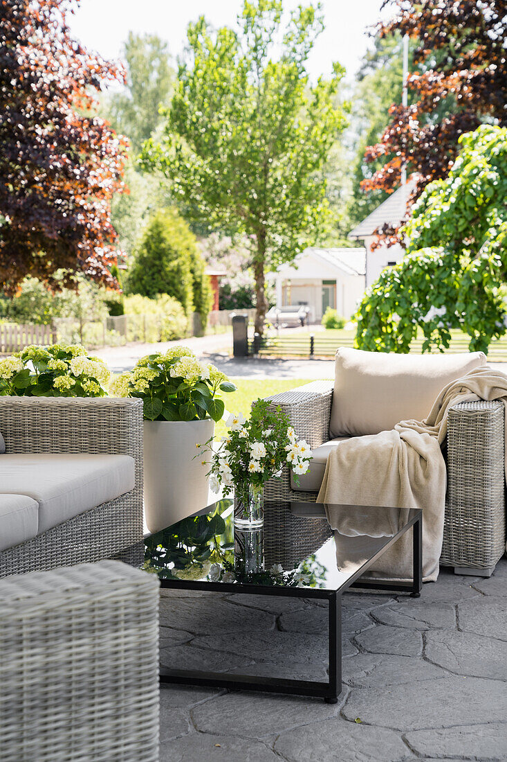 Rattan furniture and black table on terrace