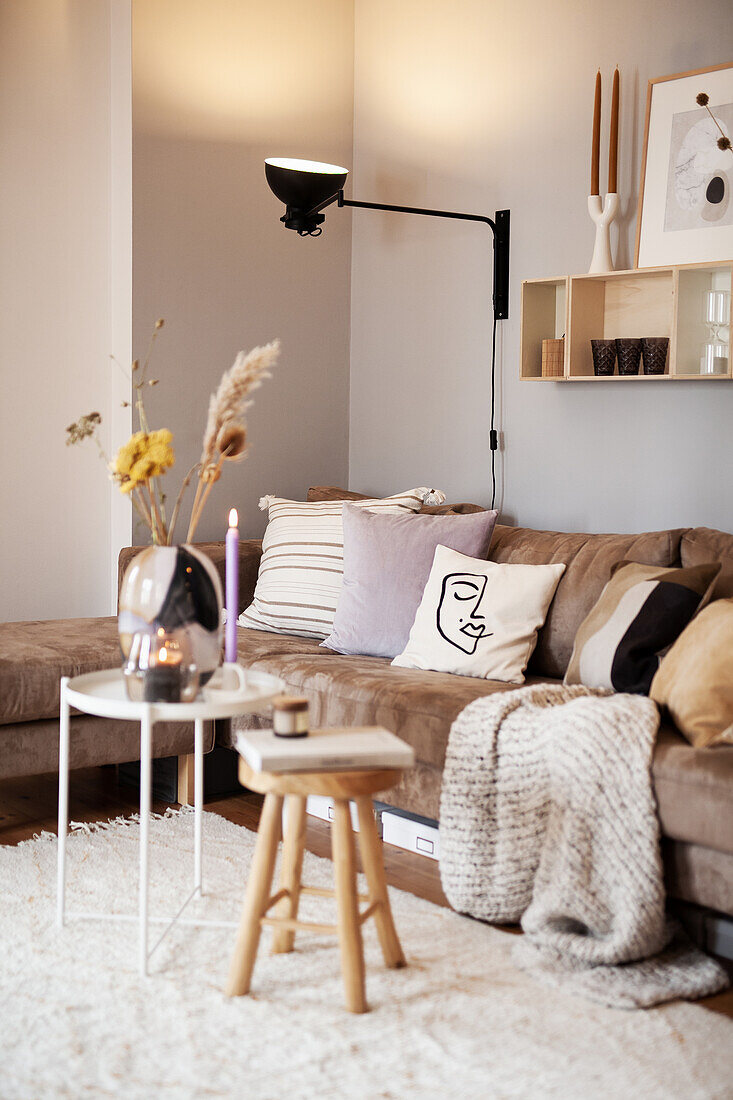 Living room in earth tones with cosy sofa and cushions