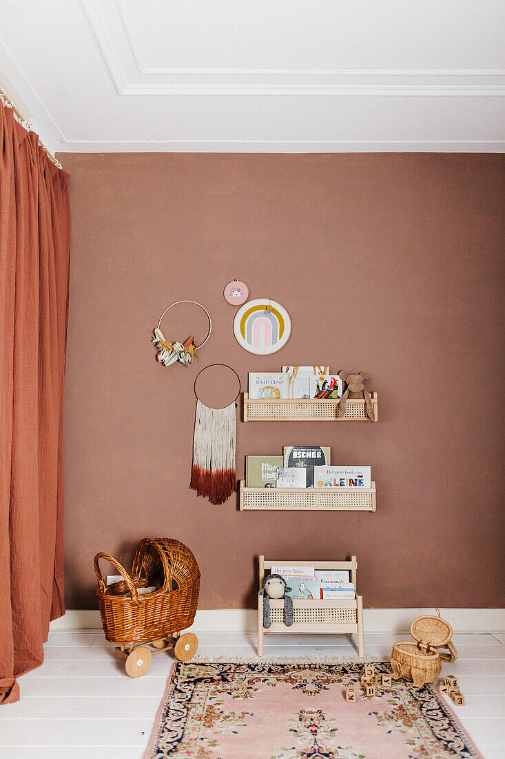 Shelves and decorations on brown wall in child's bedroom