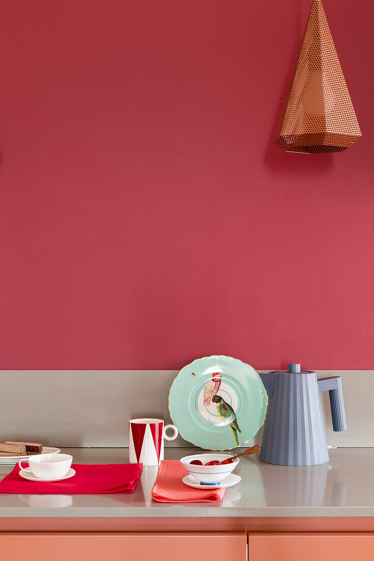 Kitchen worktop against red wall