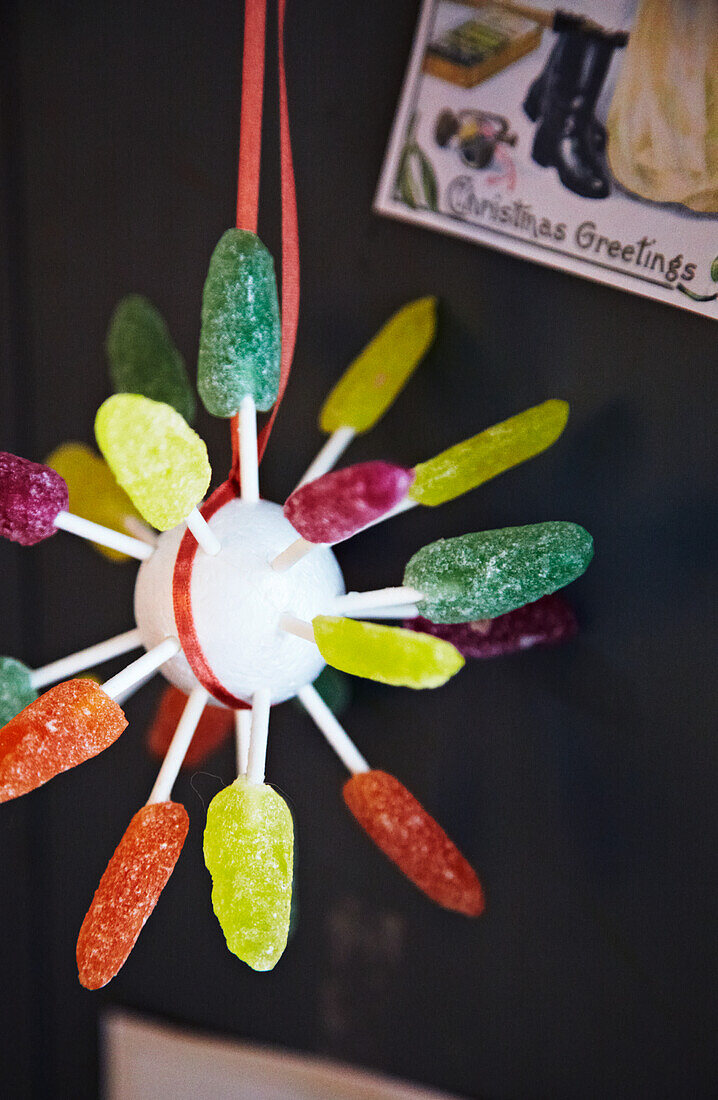 DIY Christmas decoration with sweets on a red ribbon