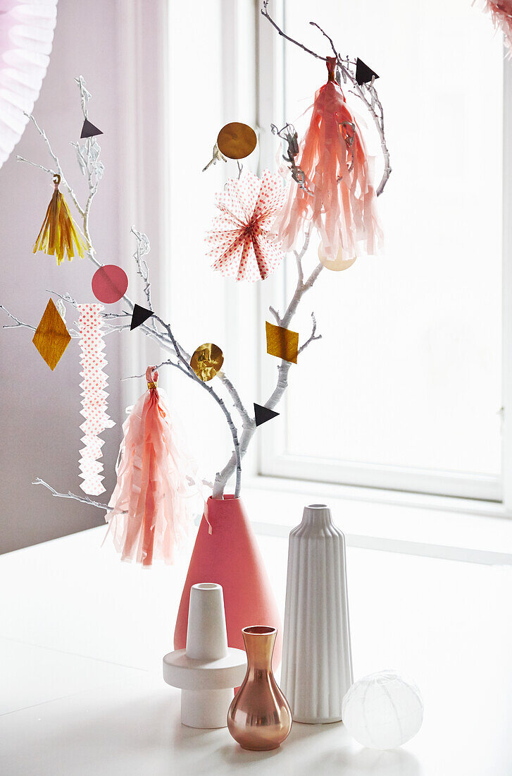 Branches with DIY party decoration in a vase
