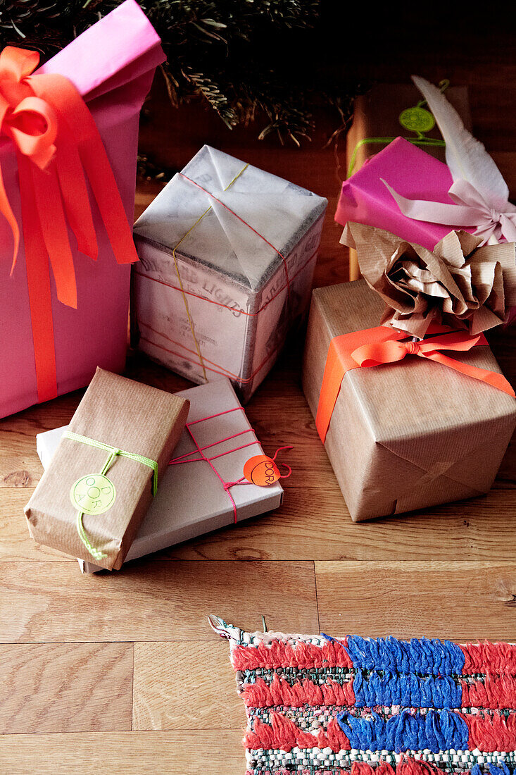 Wrapped presents in various sizes on a wooden floor