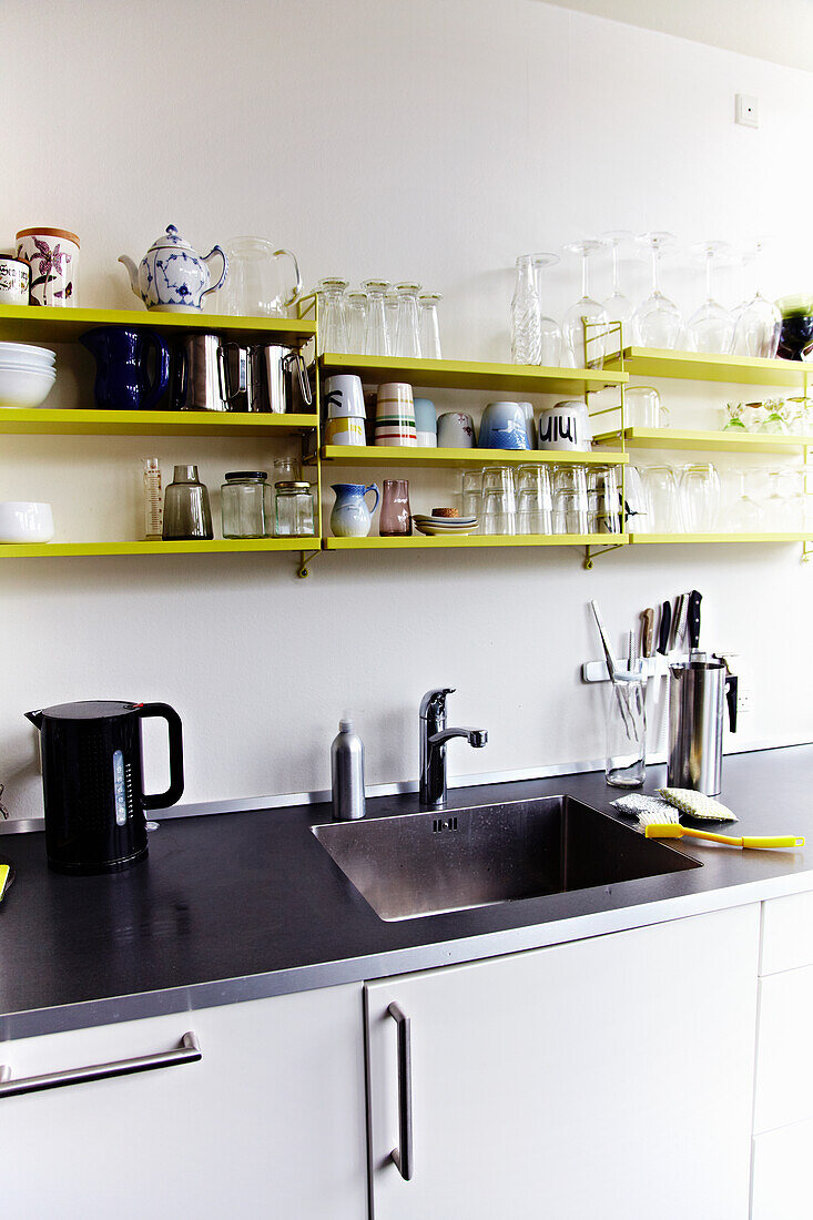 Kitchen unit with shelves in yellow and black worktop