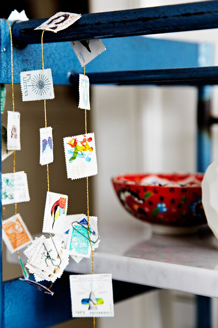 DIY garland of stamps on a blue shelf