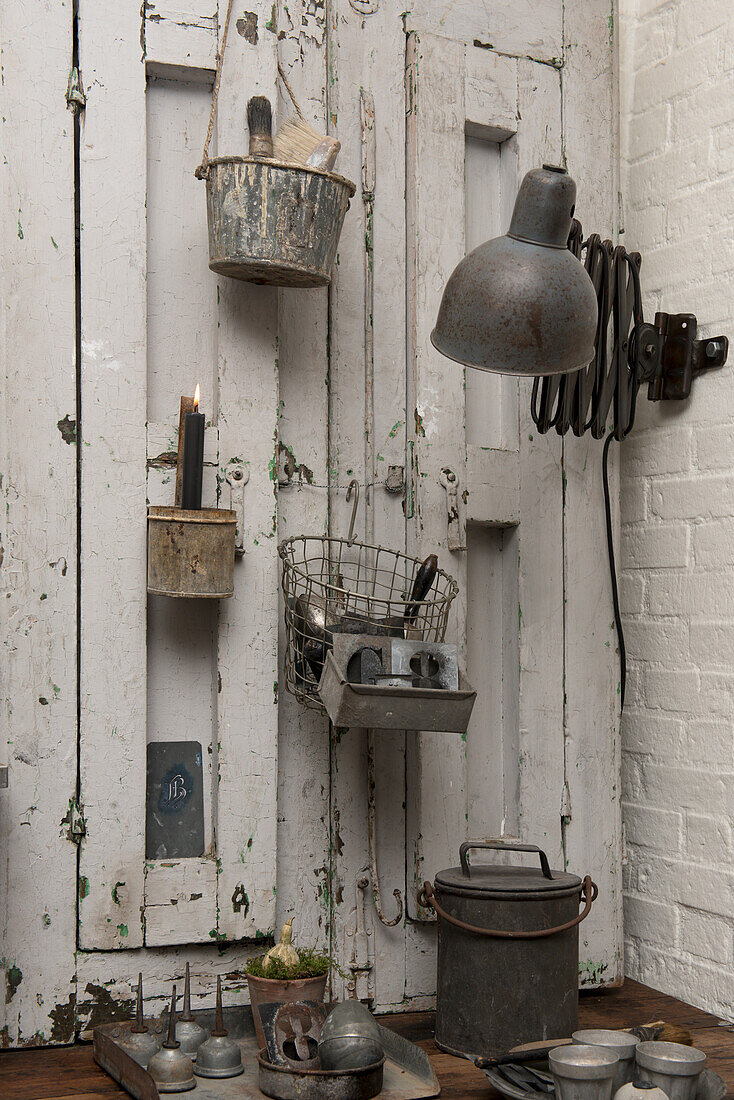 Vintage accessories on white painted paneled wall and brick wall