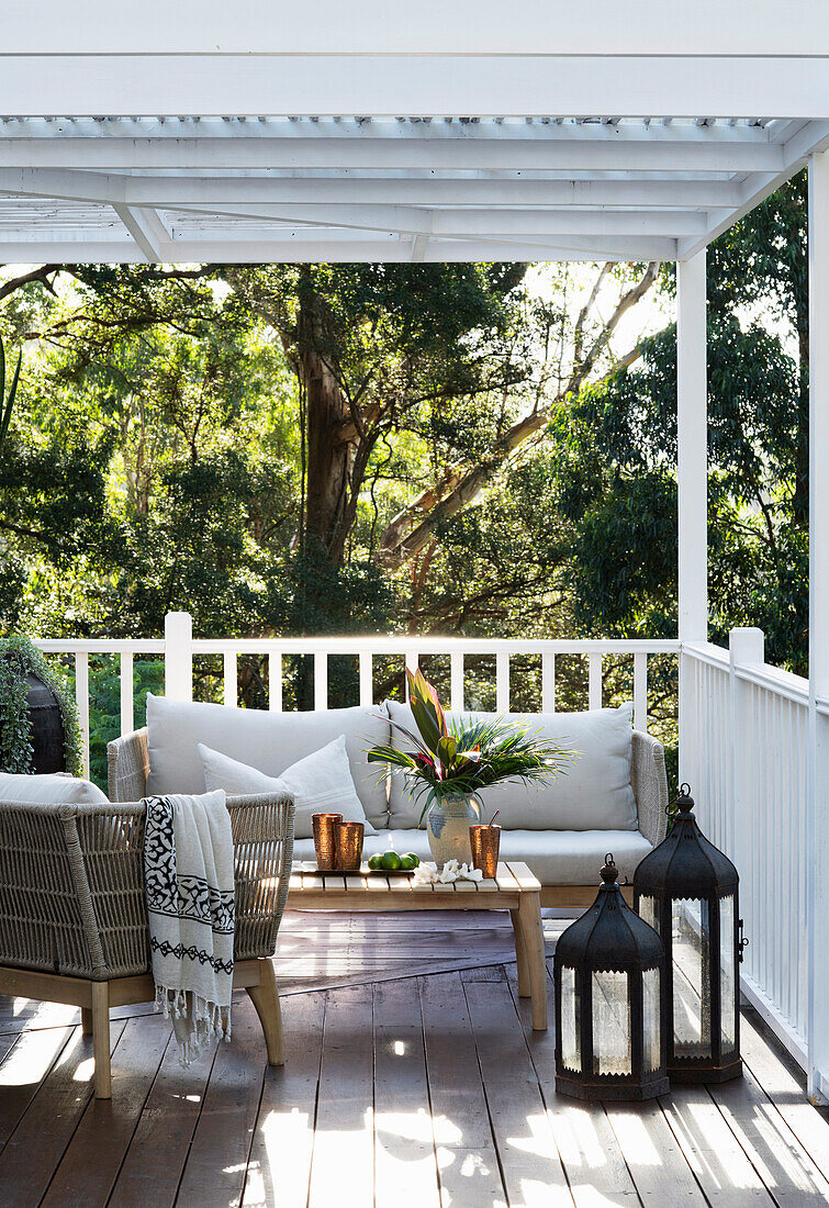 Outdoor furniture and oriental lanterns on a covered porch