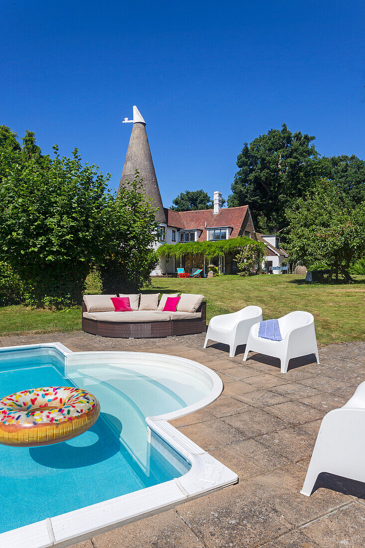 Pool with rubber ring and outdoor furniture on terrace