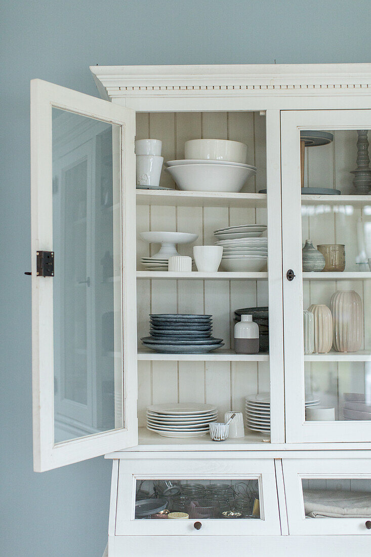 White, country-style dresser with open door