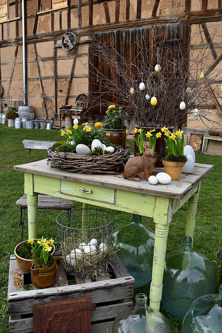 Rural Easter decoration with daffodils, Easter eggs and Easter bunny
