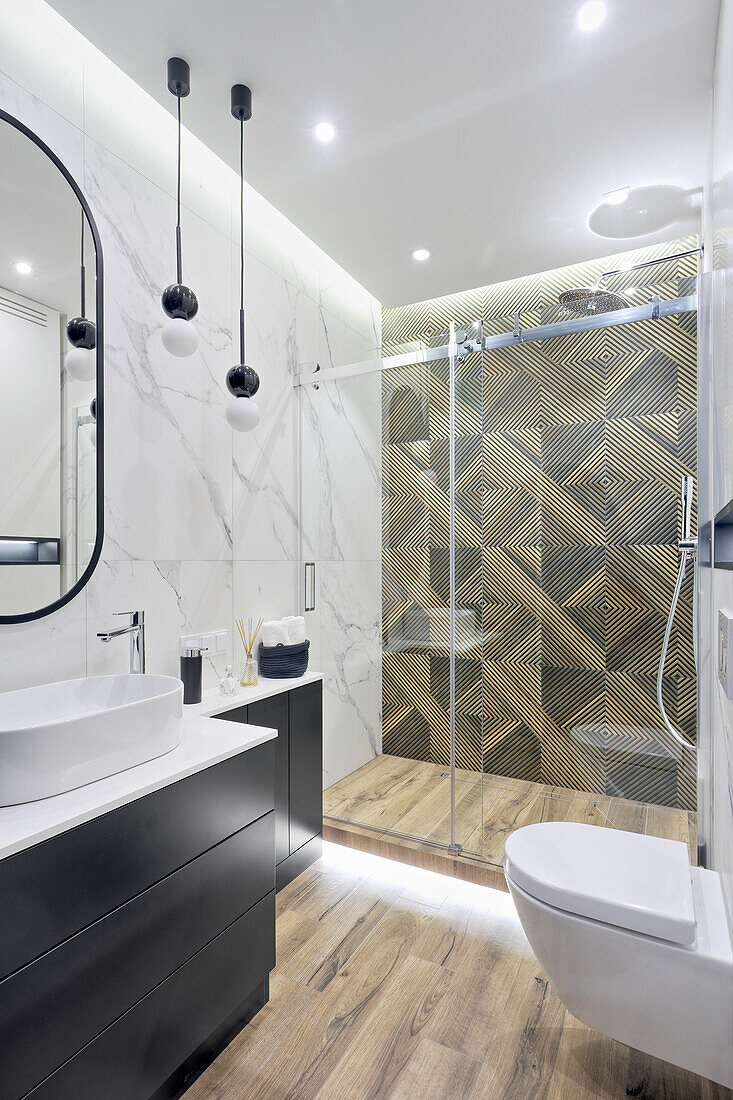 Elegant bathroom with marble tiles and shower cubicle