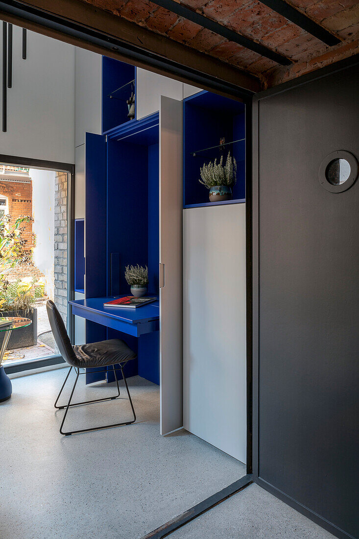 Integrated workstation in blue and grey, tiled ceiling