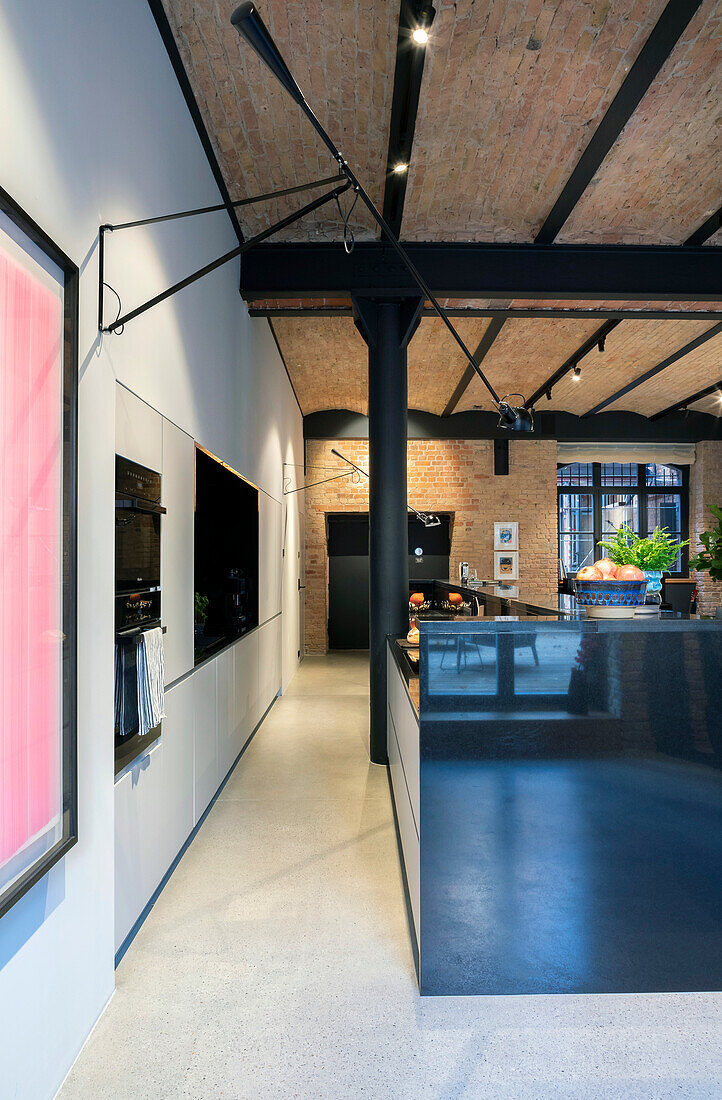 Industrial-style kitchen with brick ceiling and black metal elements